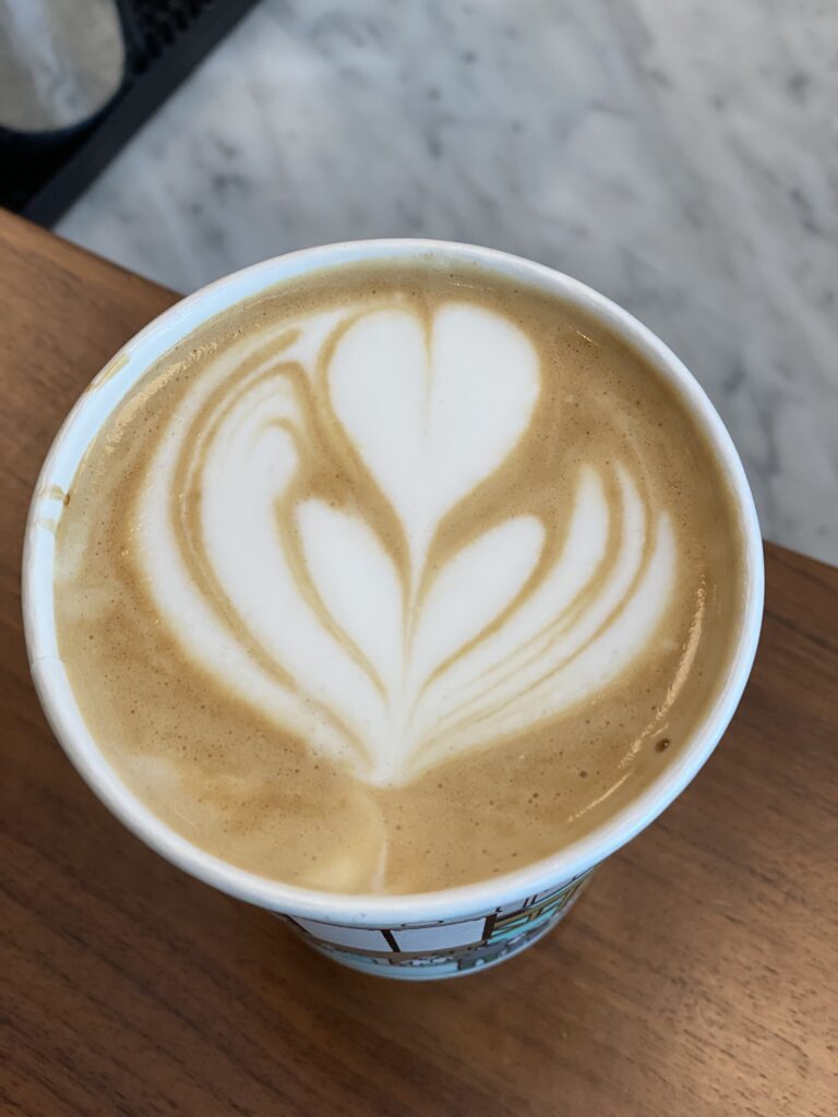 latte with heart-shaped foam art during a solo coffee experience